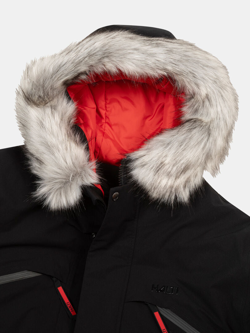The Halti 1976 Down Parka Unisex is a black winter coat with faux fur hood and red lining, ideal for extreme cold.