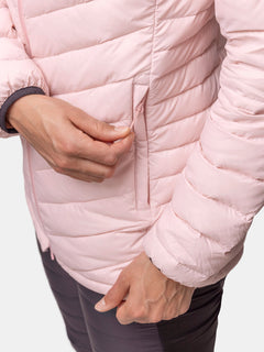 Woman zipping the Halti Huippu Mid Down Jackets pocket, made with Pertex Quantum Ripstop, against a plain background.