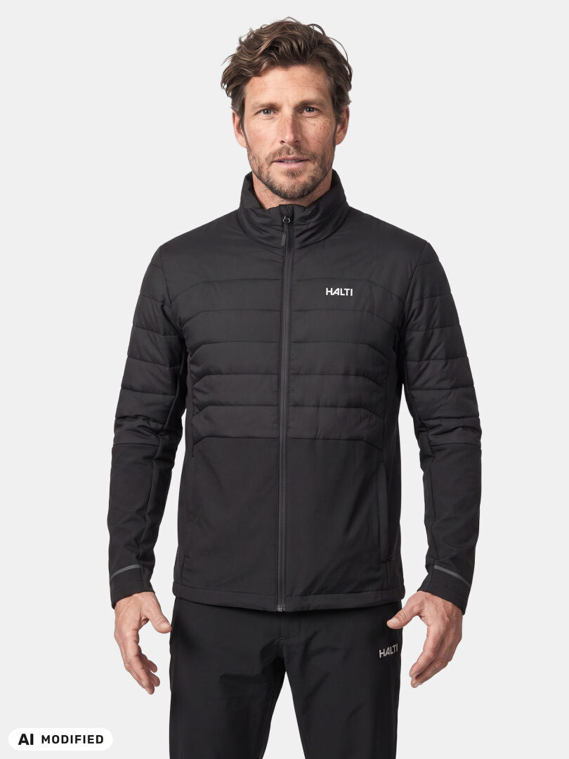 A man faces forward in a Halti Valimo Hybrid Insulation Jacket and pants, standing against a plain white background.