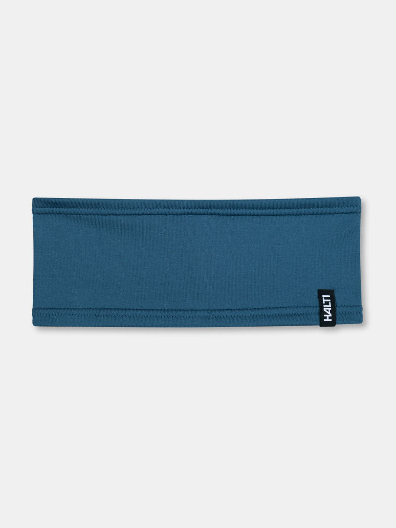 The Halti Loiva Headband, blue and recycled polyester, with a small black/white tag, laid flat on white.