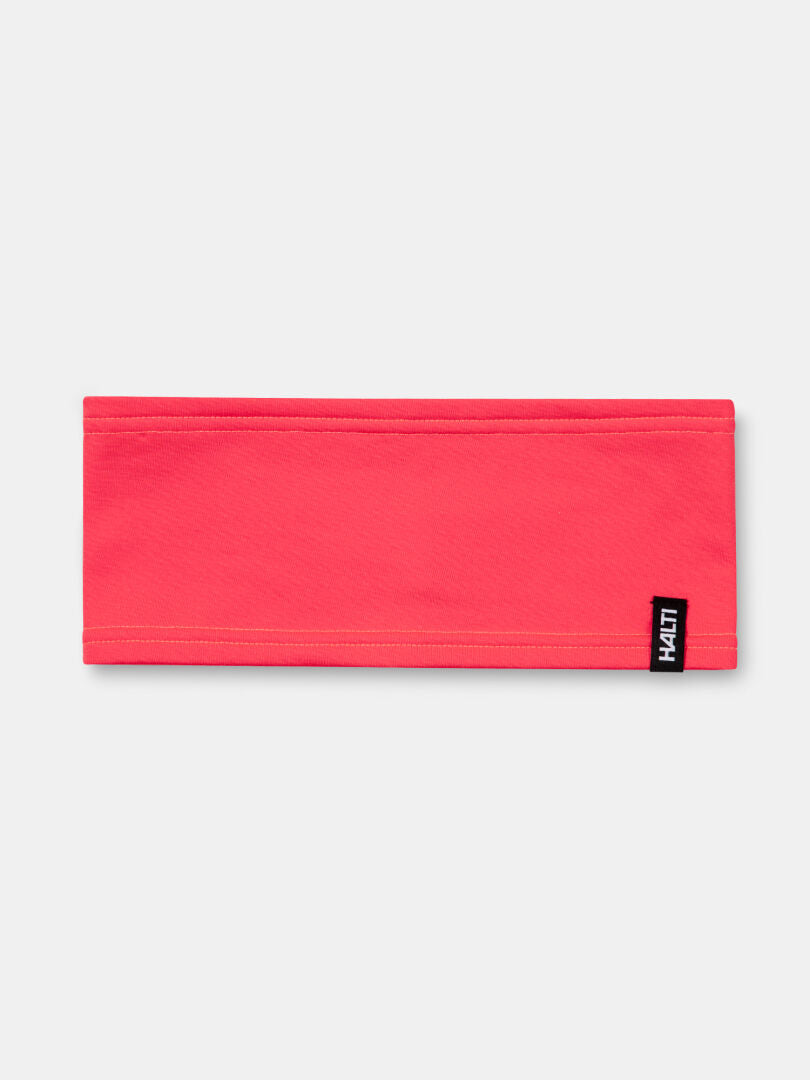 The Halti Loiva Headband is bright pink, made from recycled polyester, and features a black-and-white tag.
