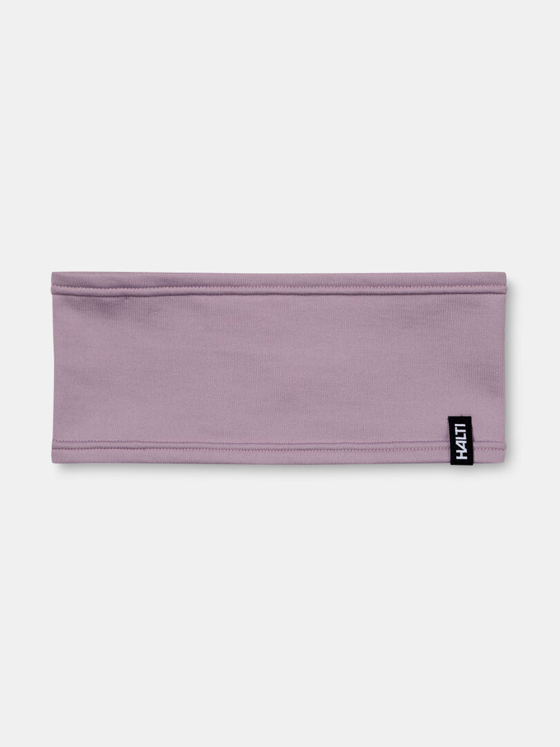 Light purple Loiva Headband by Halti in moisture-wicking recycled polyester, with small black-and-white logo tag.