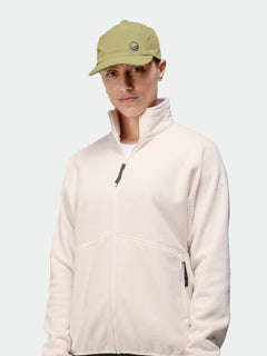 A person in a light beige zip-up jacket wears the Halti Aero II Cap, standing against a plain, light background.