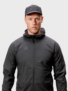 A man in a Halti Aero II Cap and black hooded jacket, facing forward against a plain light background.