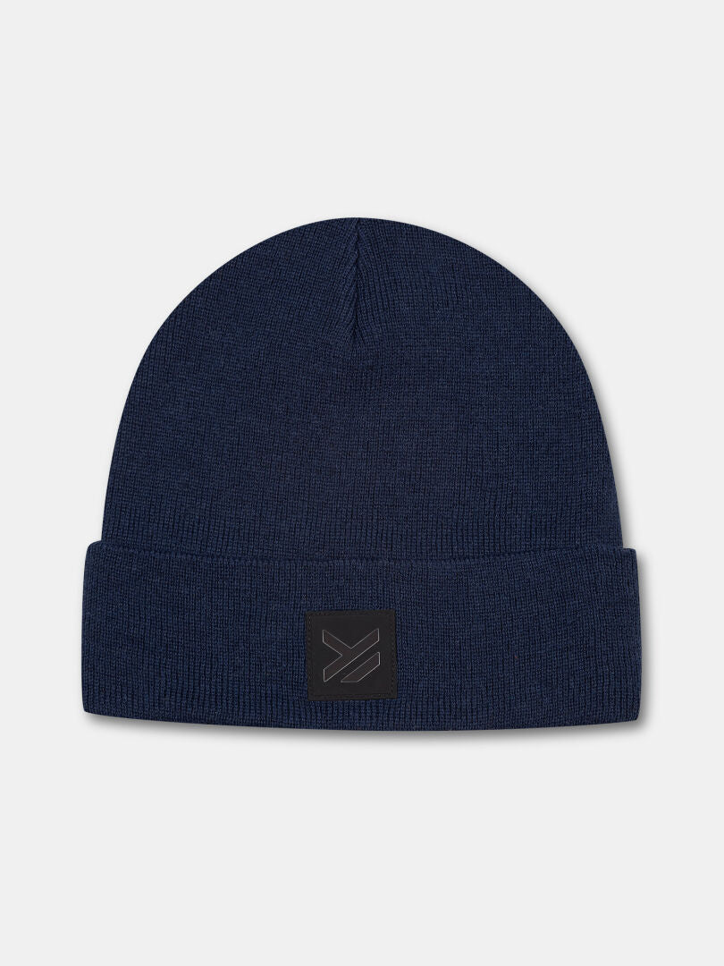 The Halti Vataja Beanie is a navy blue knit with a folded brim, crafted from recycled polyester for winter warmth.