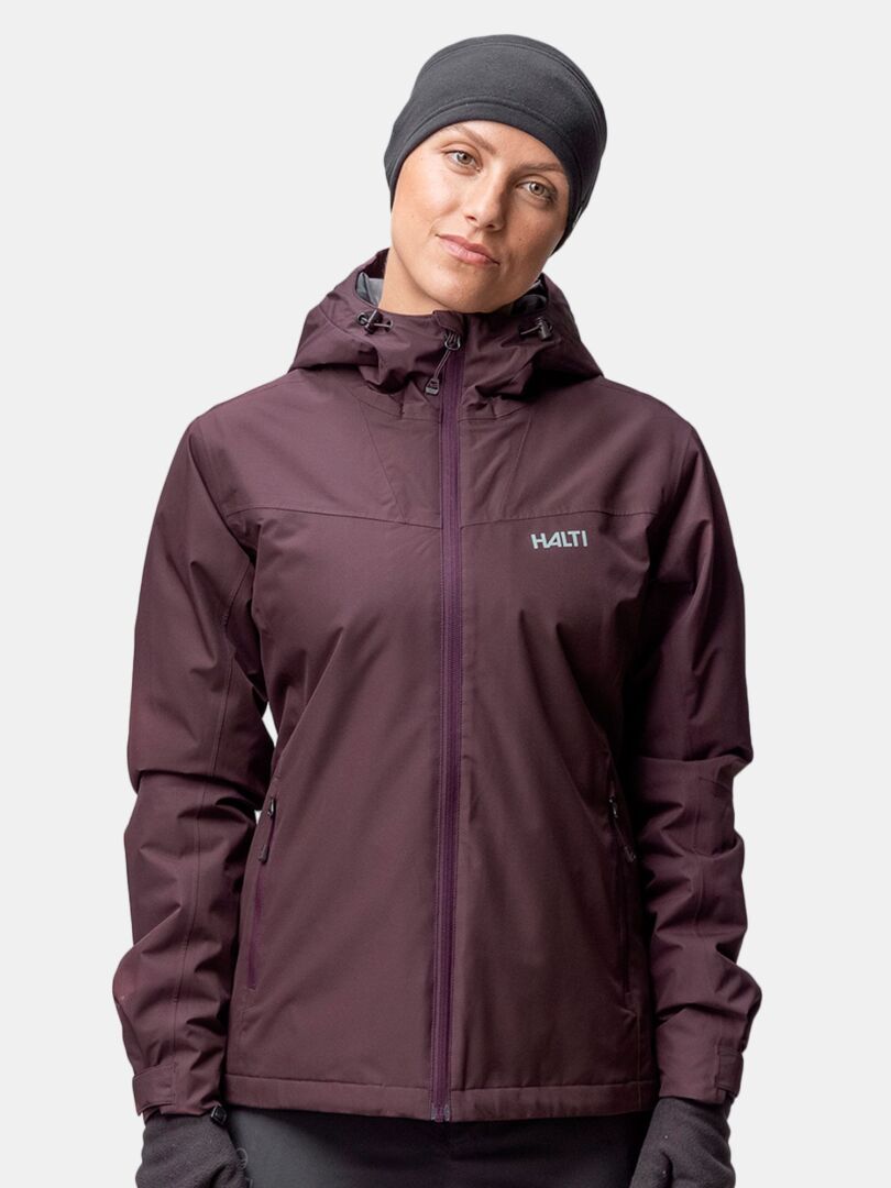 Person wearing a dark purple hooded jacket and Halti Trone Fleece Headband, standing against a plain light background.