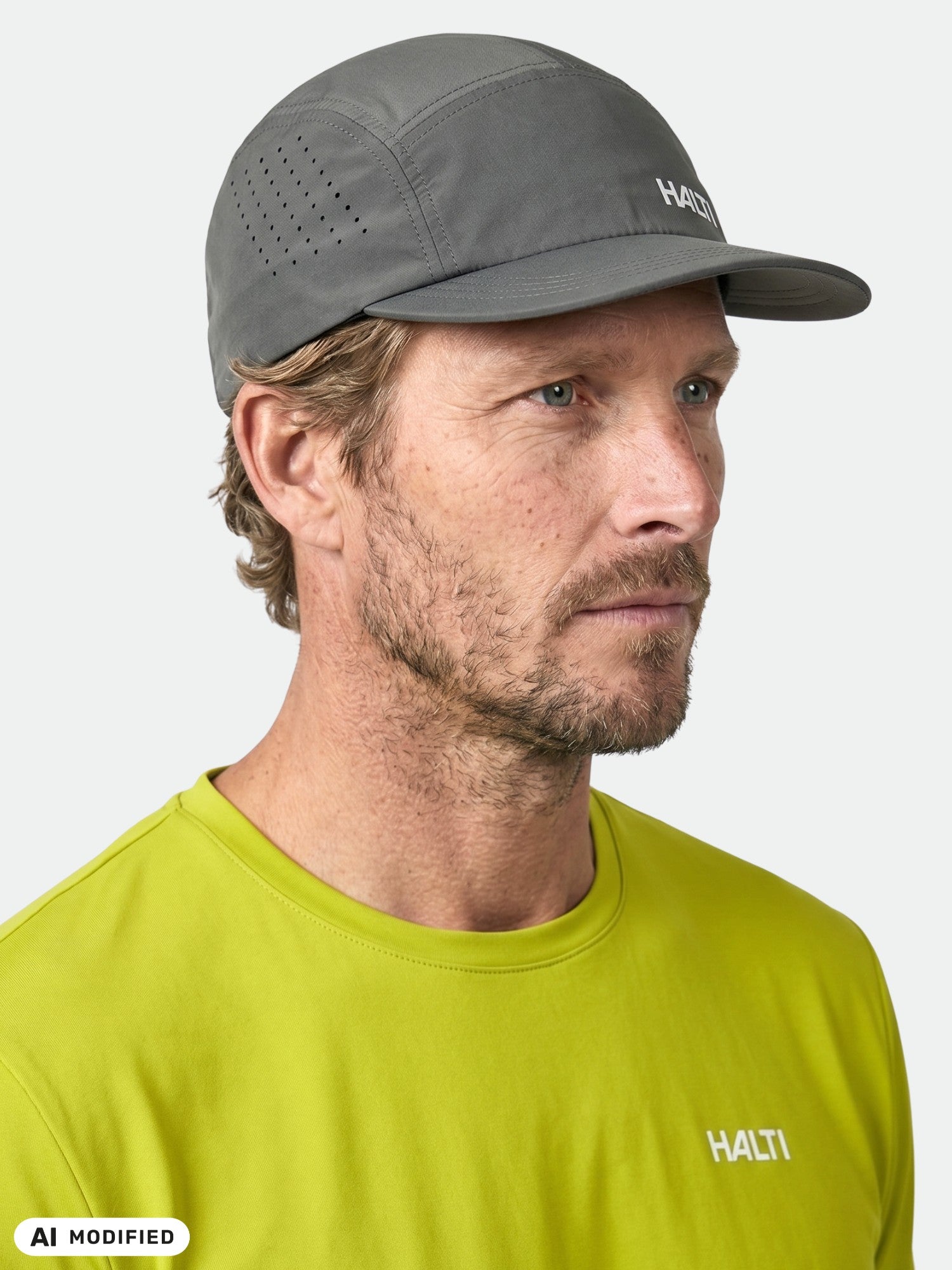 Man in a gray Halti Luovi Cap and lime green Halti shirt, facing right against a plain background.