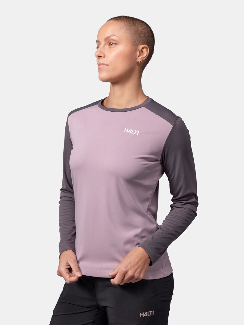 A woman wears the Halti Salves Training Shirt and black pants, standing facing forward against a plain background.