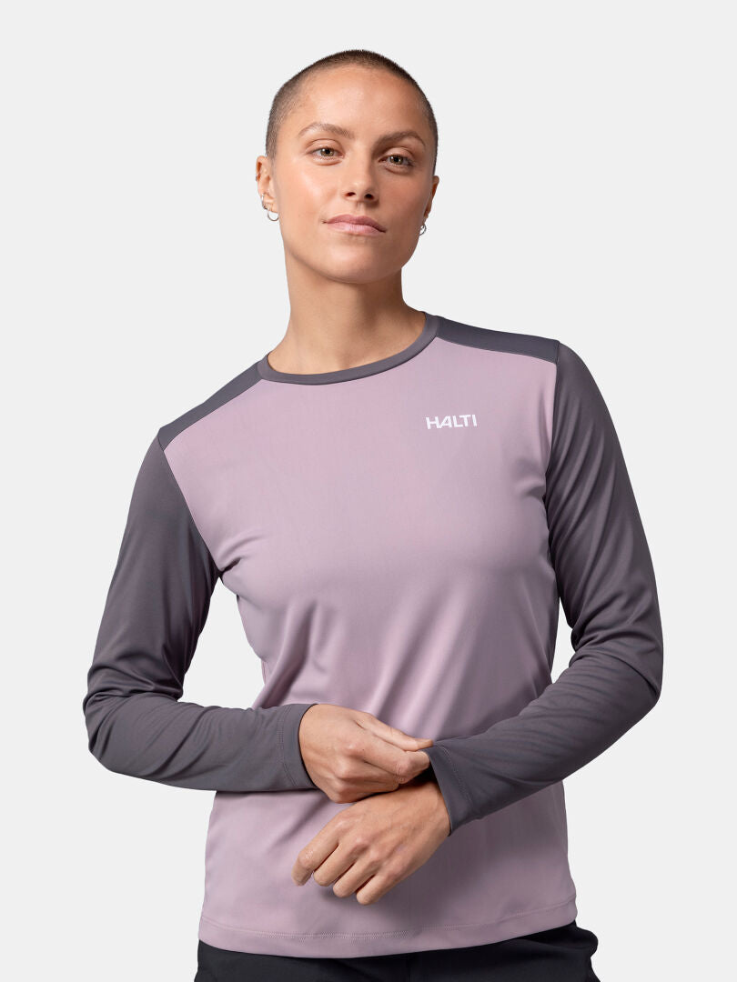 Woman with short hair wears a Halti Salves Training Shirt, posing front-facing against a plain background.
