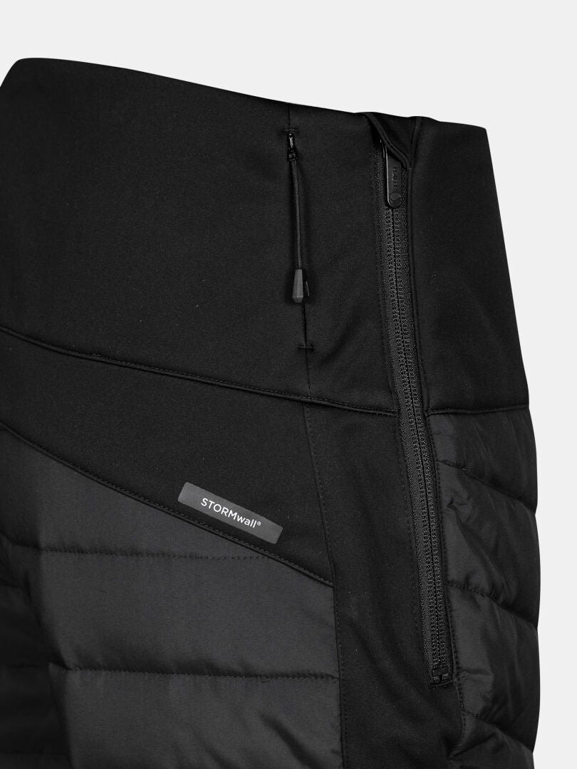 Close-up of Halti Hanki 2 Hybrid XCT Pants Women's in black, featuring a zippered pocket and Stormwall® fabric tag.
