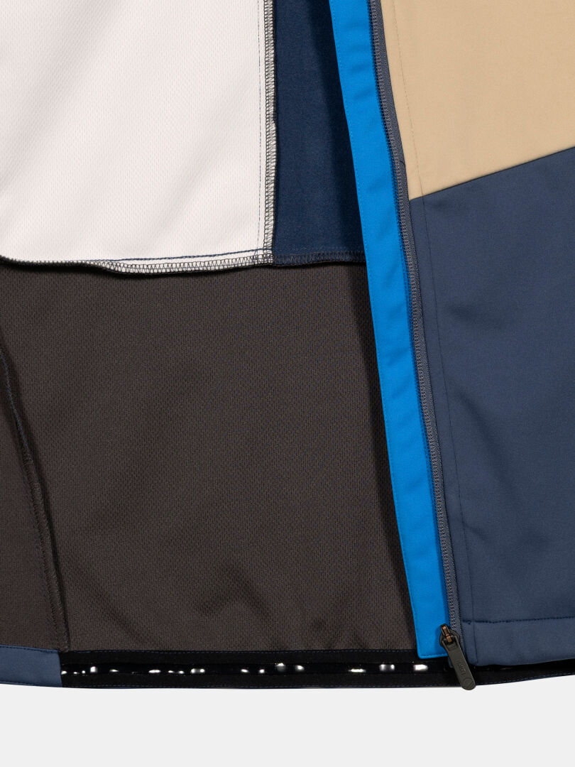 Close-up of Halti Framover XCT Jacket Men's, featuring color-blocked blue, beige, white & gray panels and a blue zipper.