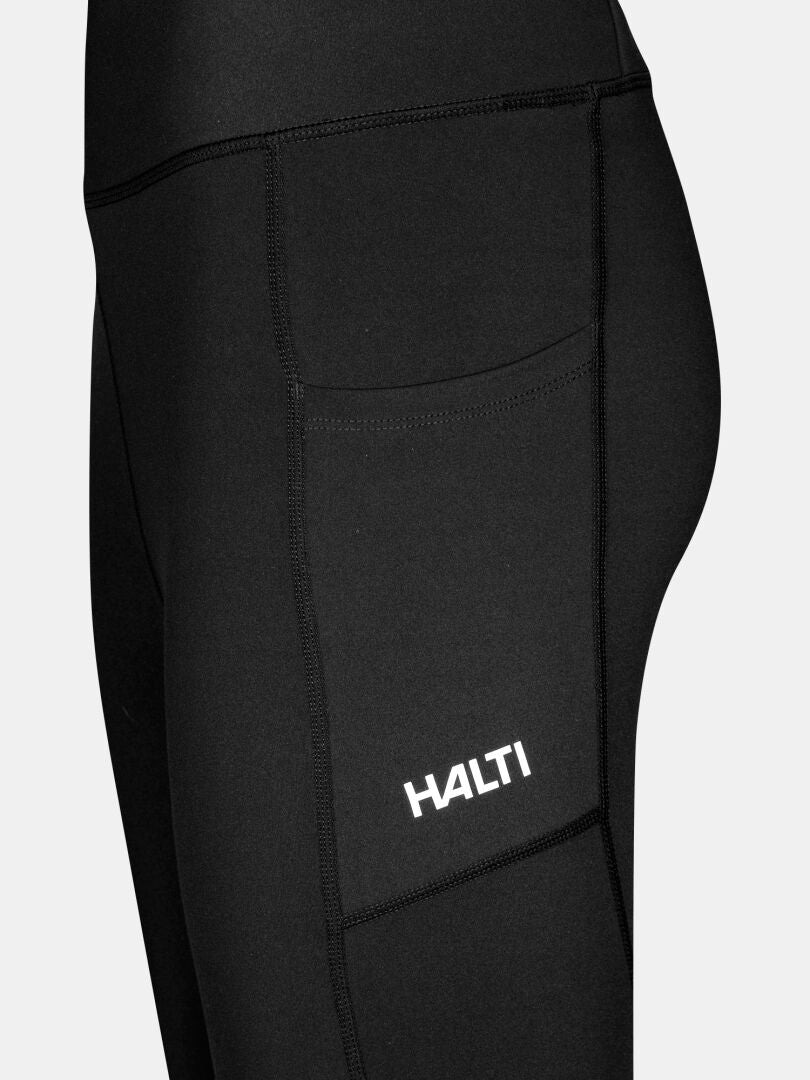Close-up of Halti Kaldu Women's Training Tights in black, featuring a side pocket with white Halti branding.