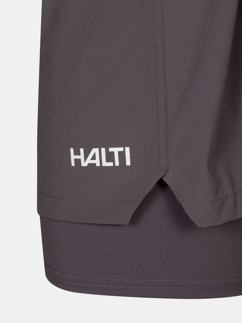 Close-up of Uurto Shorts Women's by Halti, showing the grey hem, white logo, and a small side slit detail.