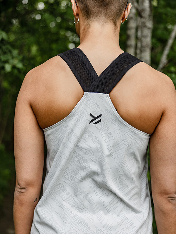 Person with short hair seen from behind, wearing a Halti Oulanka Training Top Women's with black straps outdoors.