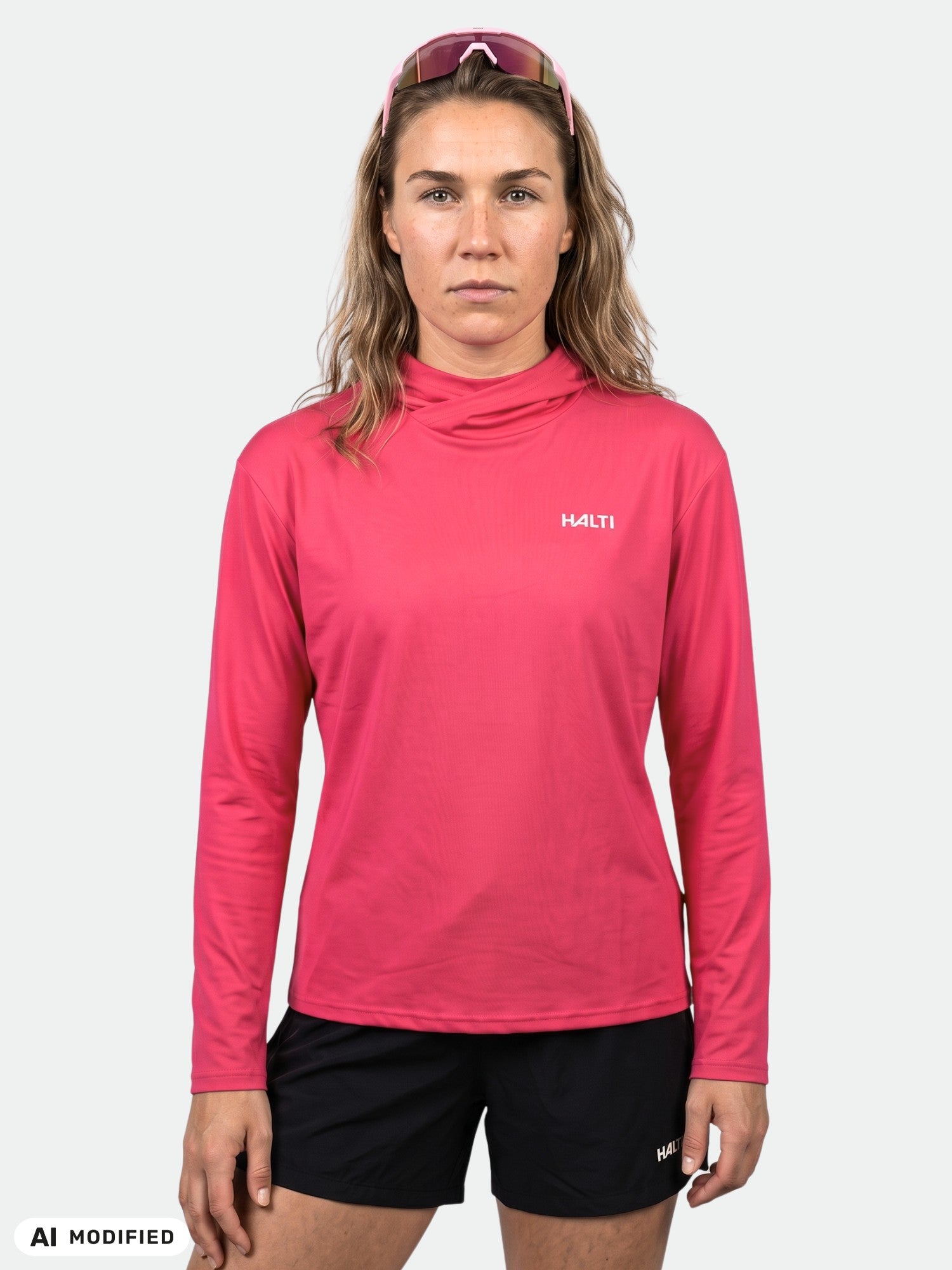 A person wears a pink Halti Kaltio Training Hoodie Women's and black shorts, facing forward against a plain background.
