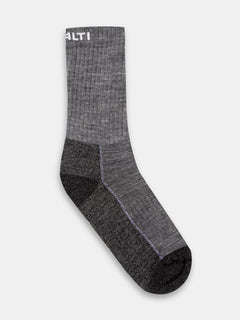 A single gray Halti Trekking Warm Merino Sock, mid-calf with dark heel/toe and partially visible white text at cuff.