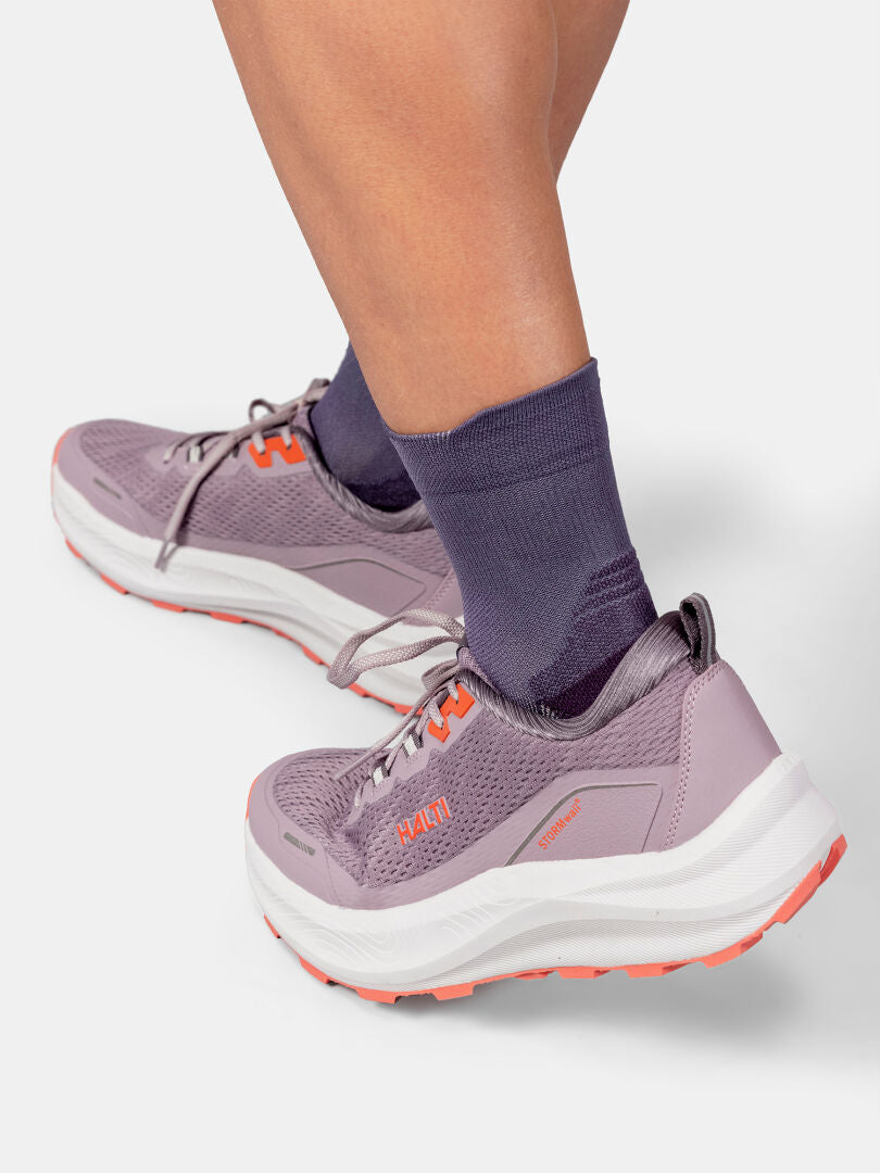 Person wearing Halti Active Sport Socks and purple athletic shoes, standing on a white background.
