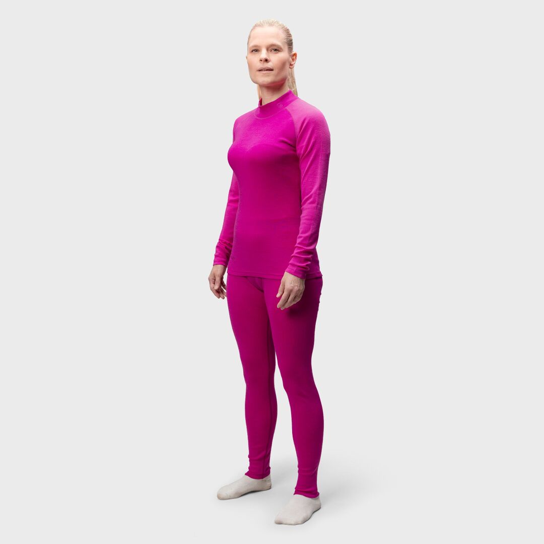 Person facing forward in Halti Neva Merino Base Layer Set Women's, magenta color, paired with light socks.