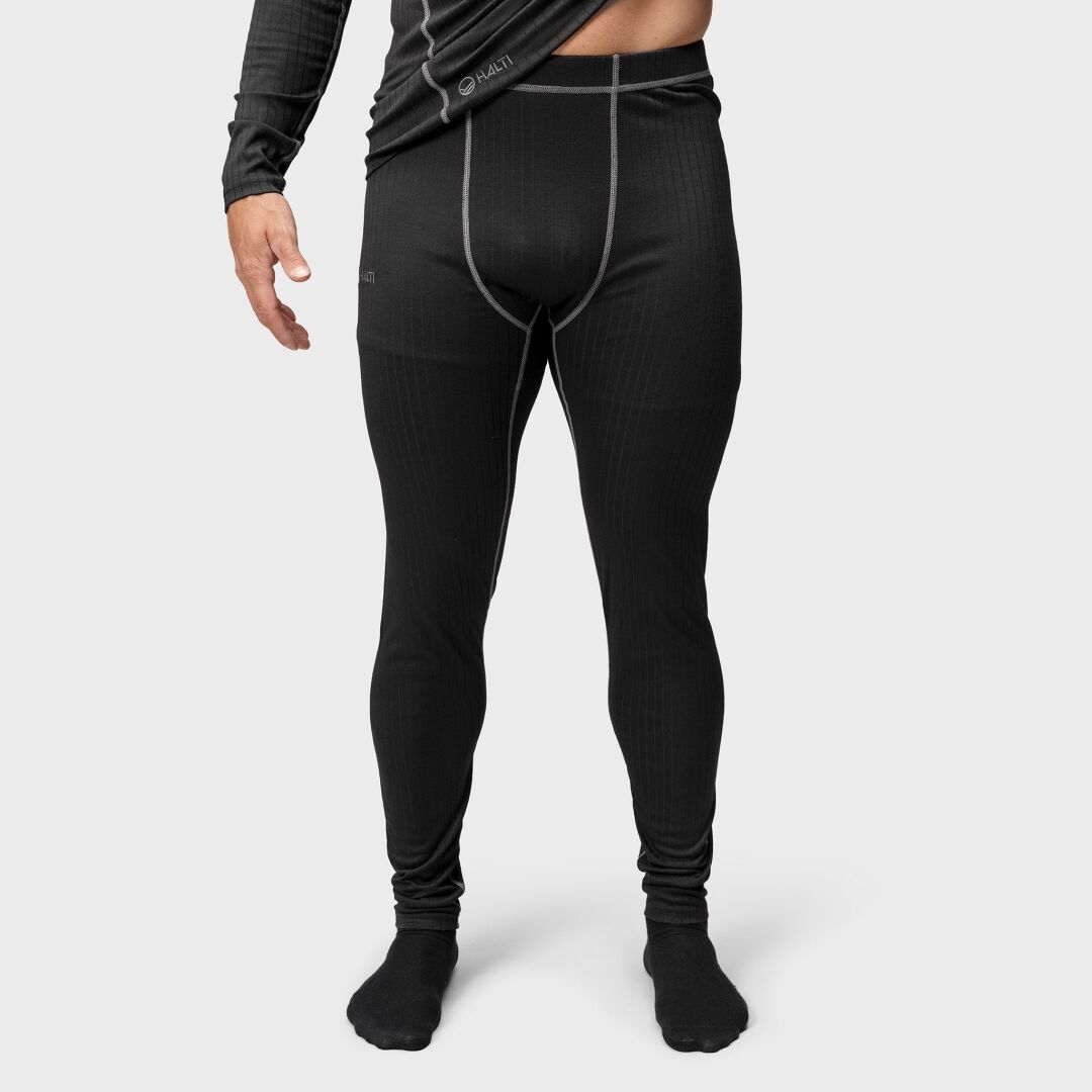 A man in the Halti Dual Base Layer Set stands on a light background, ready for outdoor adventures.