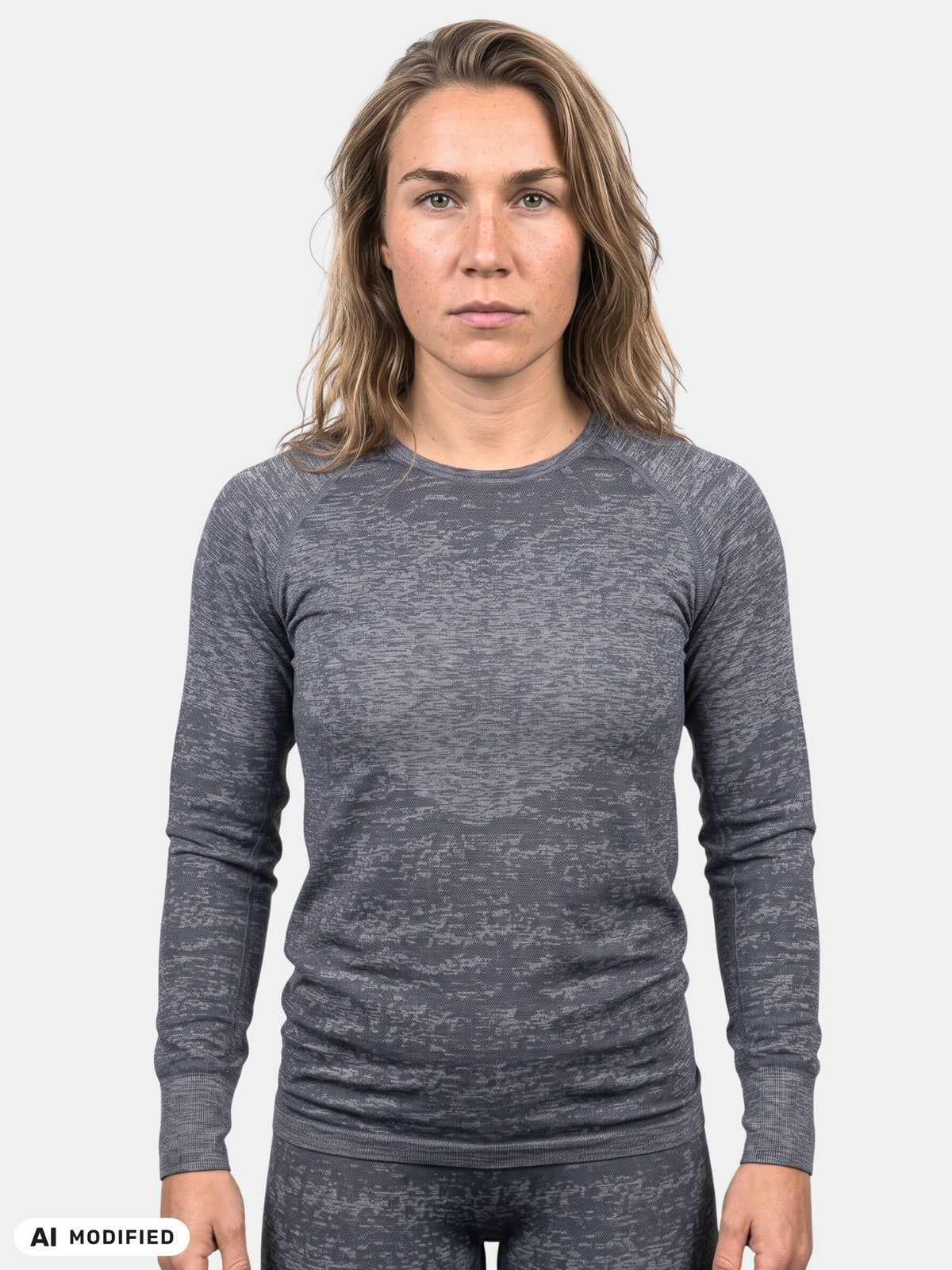 Woman wearing a charcoal grey Halti Free Seamless Baselayer Set Women’s long-sleeved top.