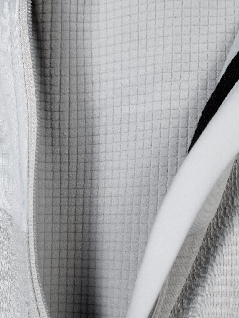Close-up of Halti HeatGrid Layer Jacket Men's, showing grid-patterned fleece lining and part of the zipper.