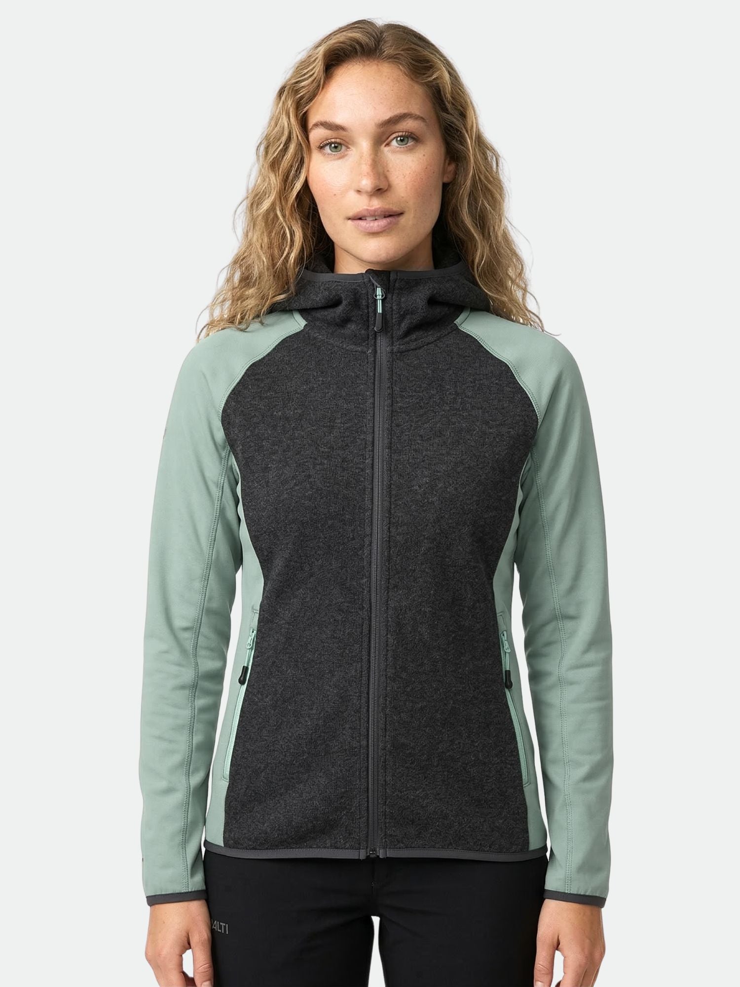 A woman wears the Halti Circuit II Hoodie Women's, featuring light green sleeves and a dark grey Active Dry front.