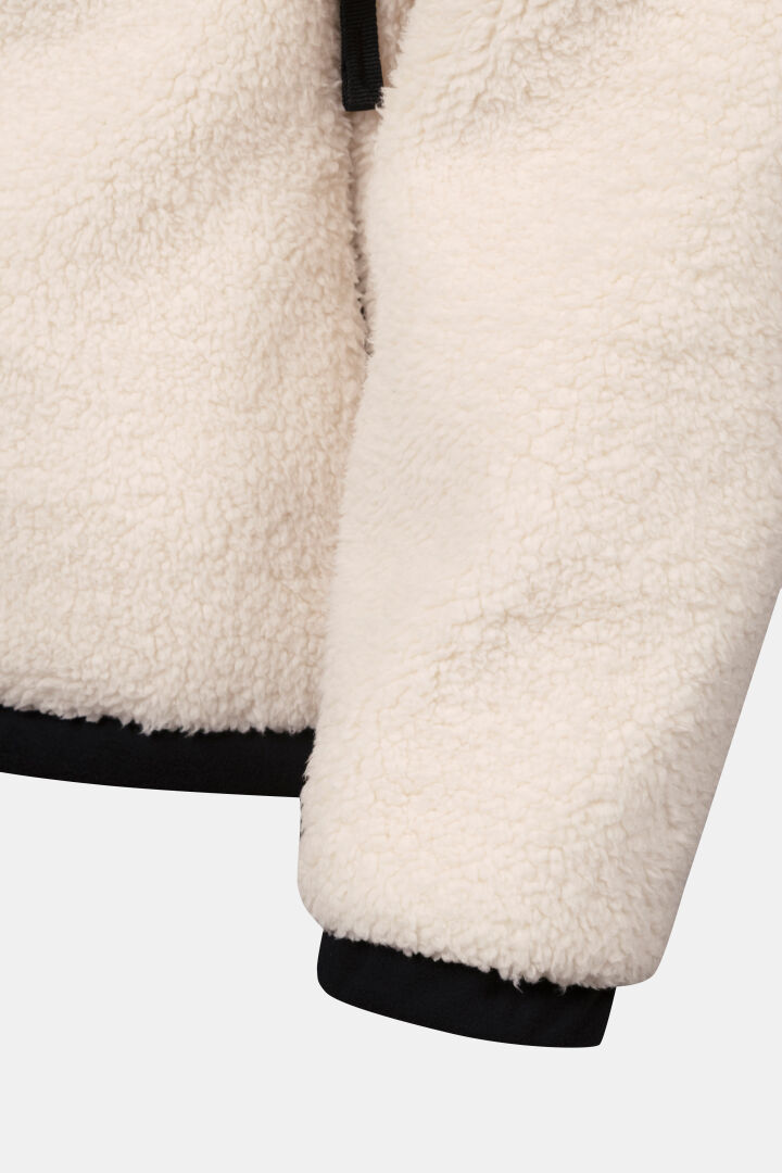 Close-up of Halti Lumista Polar Fleece Jacket Women’s sleeve with black trim at cuff and hem, on white background.