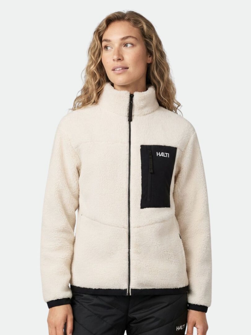 A woman wears the Halti Lumista Polar Fleece Jacket with black zip pocket, standing against a plain background.