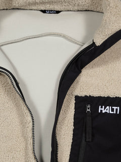 Close-up of the Halti Lumista Polar Fleece Jacket Mens, featuring a black zippered chest pocket and logo.