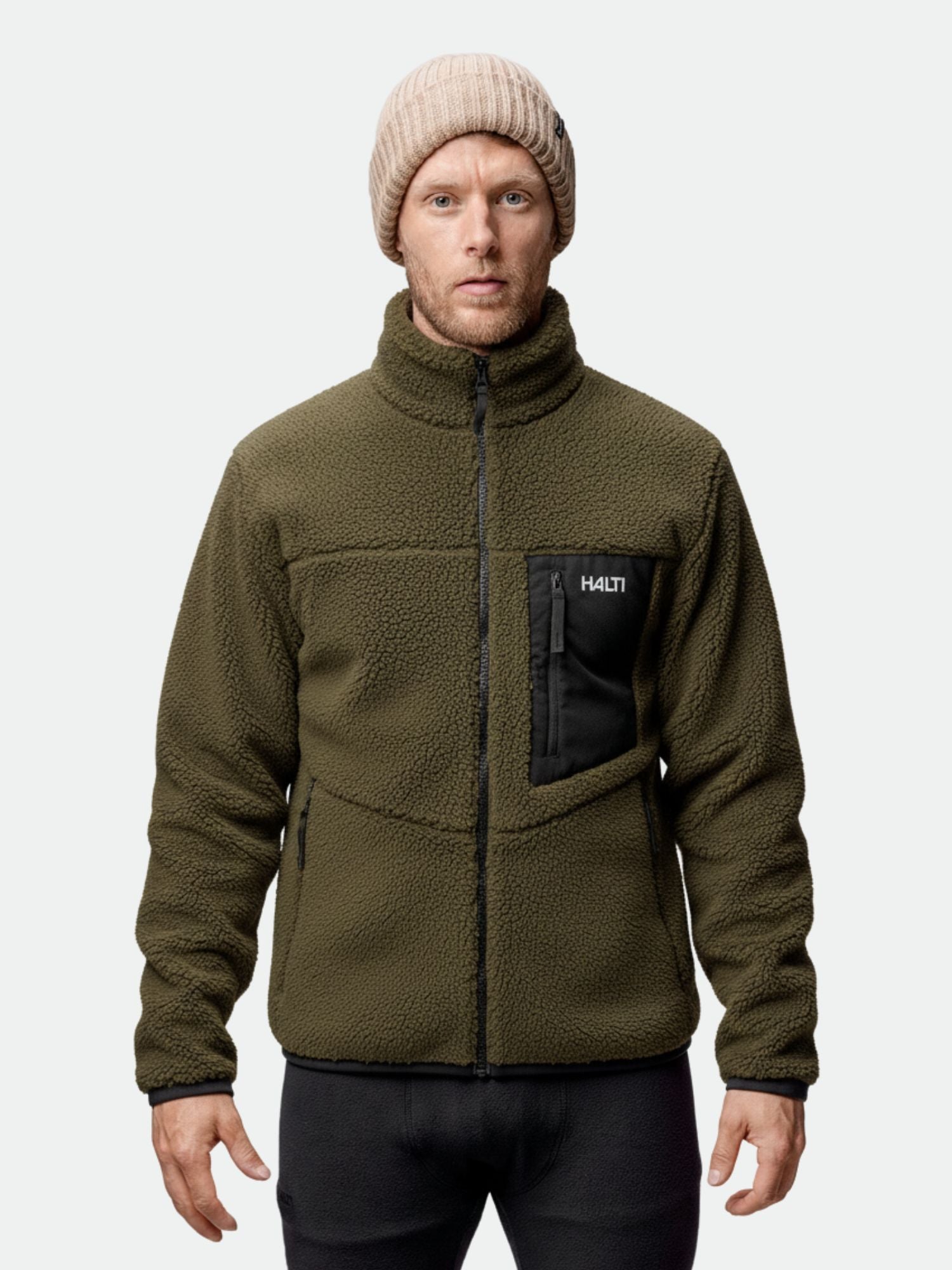 A man in a Halti Lumista Polar Fleece Jacket and beige knit beanie faces forward against a plain background.