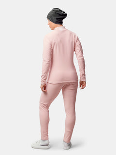 A person wears the Halti Trone Fleece Shirt for women, with matching pants, gray beanie, and white shoes.