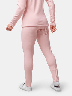 Woman shown from the back wearing Halti Trone Fleece Pants and a light pink long-sleeve top with white slippers.