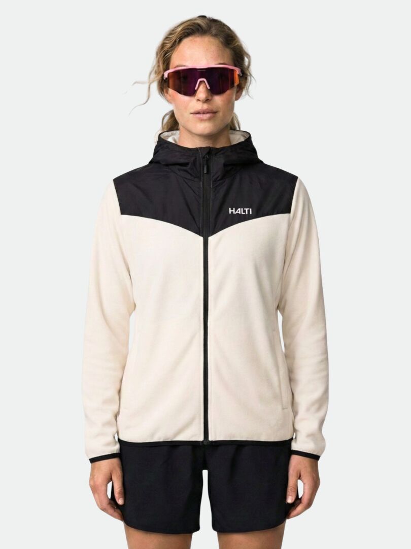 A woman in sunglasses wears the Halti Rockmoon Fleece Hoodie and shorts, standing facing forward.