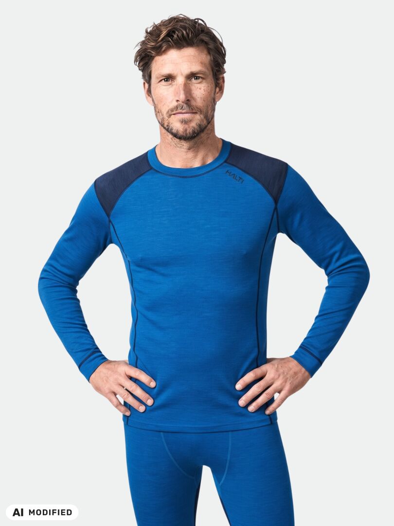 Man in Halti Hossa II Merino Base Layer Set, hands on hips—premium men’s merino wool sportswear for outdoors.