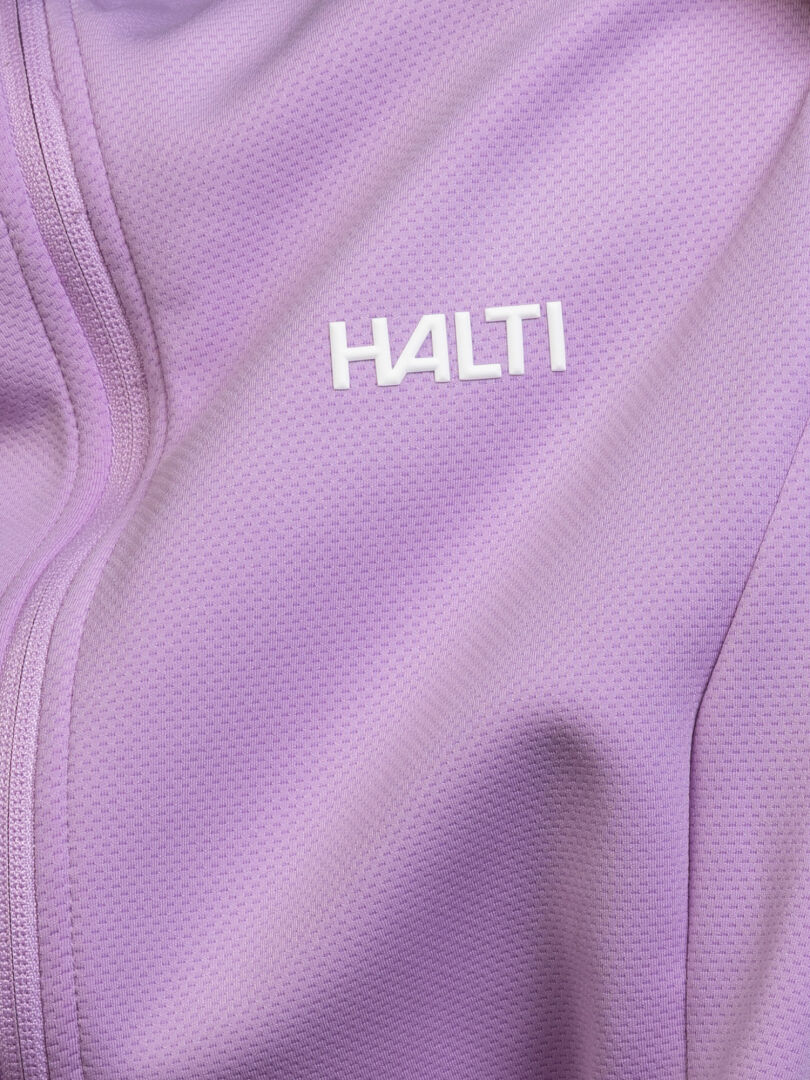 Close-up of the Halti Kivikko Layer Jacket Women’s in light purple with a white logo and left zipper seam detail.