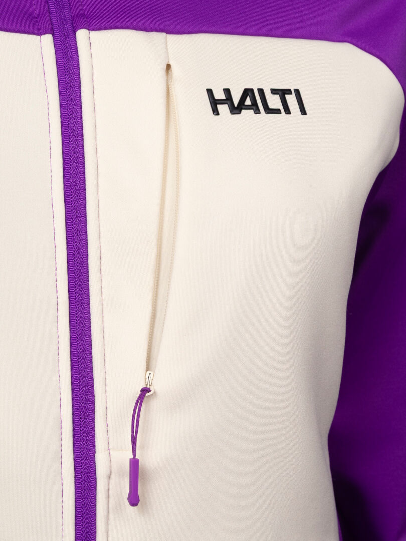 Cream and purple Halti Seiland Layer Jacket Women’s stretch fleece midlayer with a zippered chest pocket and logo.