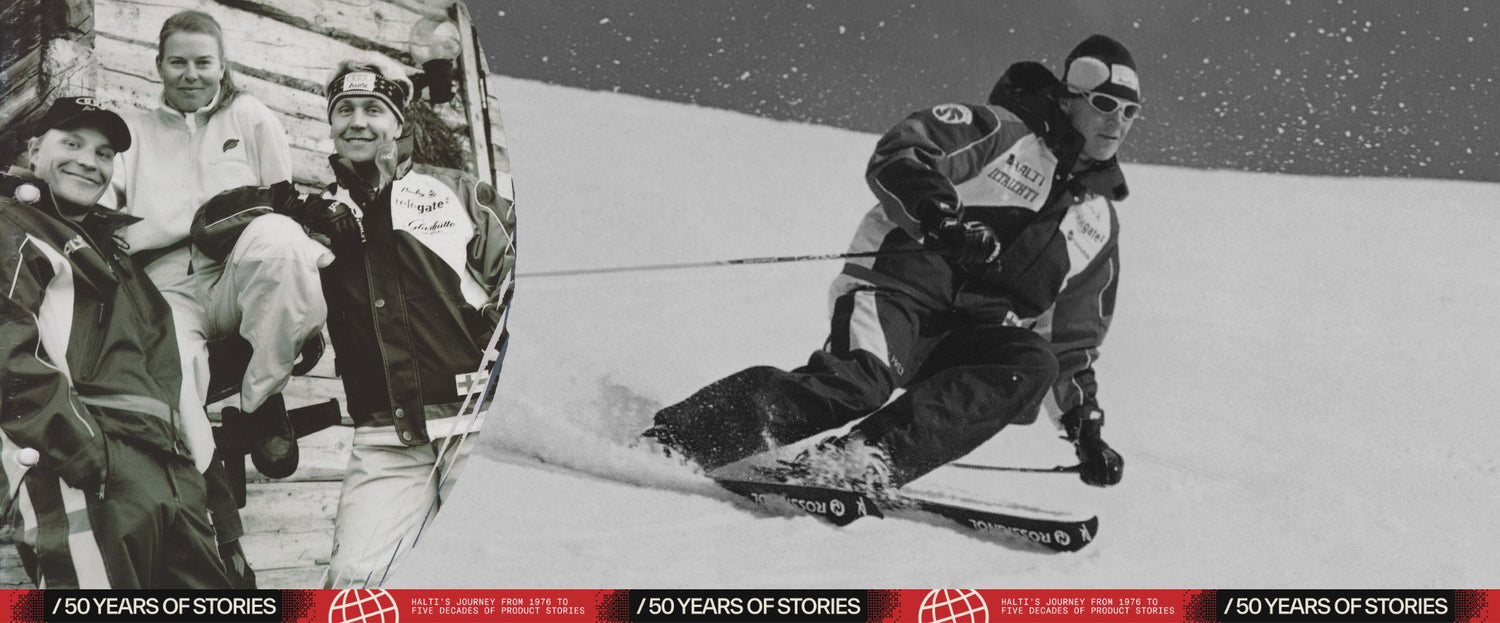 Two men skiing down a snowy slope with a scenic background.
